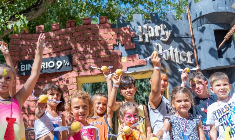 Children celebrating in front of Harry Potter's Platform 9¾.