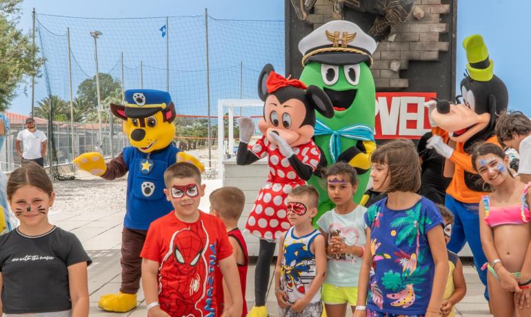 Children with costumes and characters at an outdoor event.