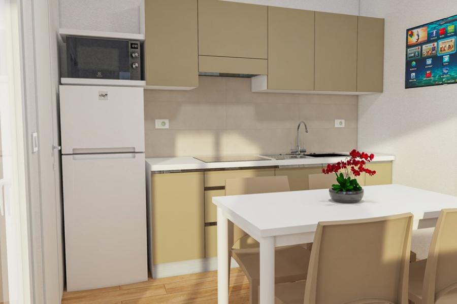 Modern kitchen with white table and red flowers.